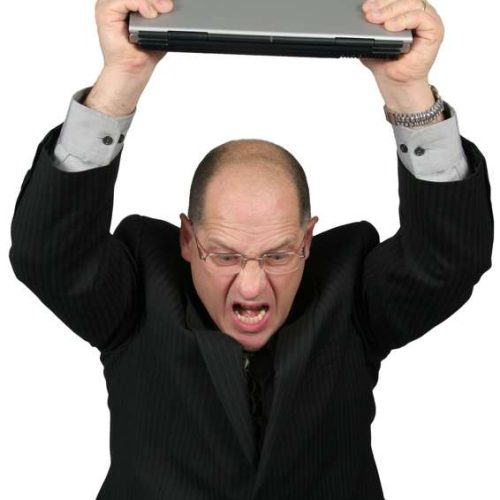 Business man with Laptop over head, man is mad with his computer
