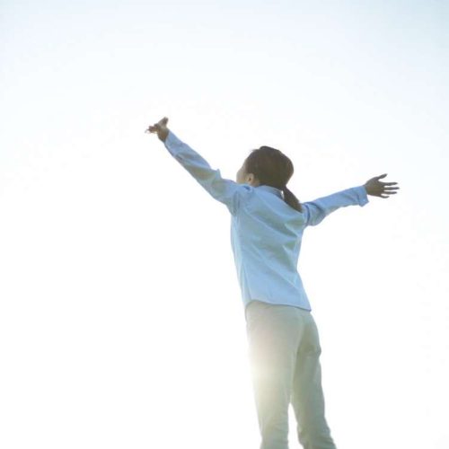 Woman with Arms in the Air --- Image by © Royalty-Free/Corbis