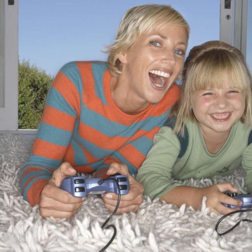 Mother and Daughter Enjoying a Video Game --- Image by © Royalty-Free/Corbis