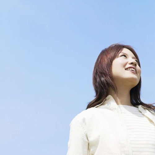 Young Woman Looking Up at Sky --- Image by © Royalty-Free/Corbis