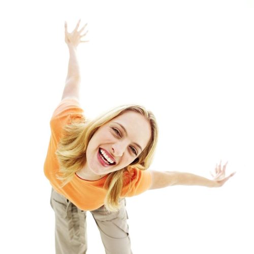 Young Woman Bending Down and Smiling with Arms Stretched Back --- Image by © Royalty-Free/Corbis